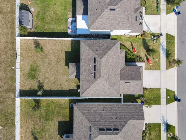 an aerial view of a house with swimming pool and ocean view