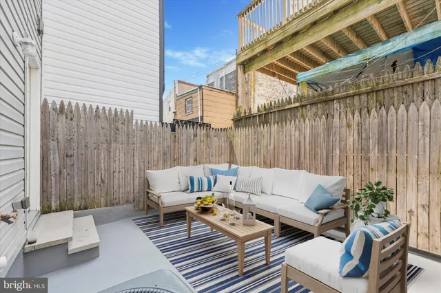 a outdoor living room with furniture and a potted plant