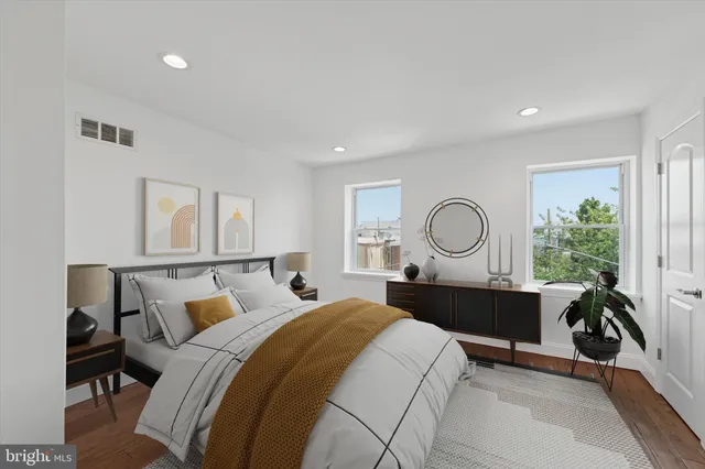 a bed room with a bed window and a potted plant