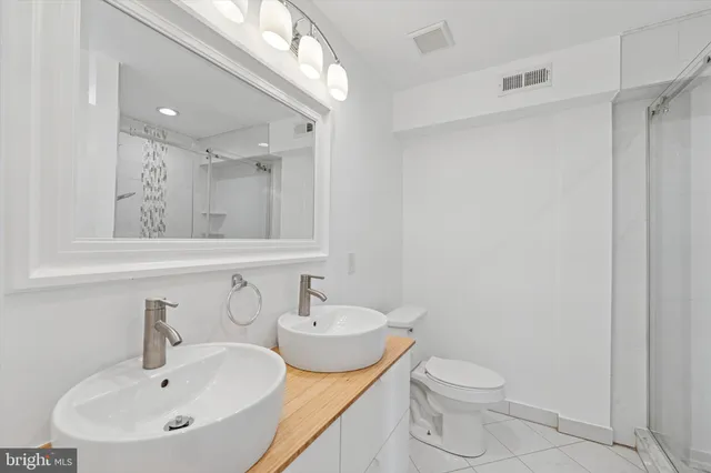 a bathroom with a sink toilet and a mirror