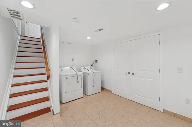 a view of a livingroom with stairs and white walls