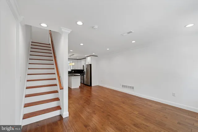 a view of a room with wooden floor and stairs