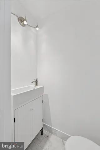 a bathroom with a sink a toilet and vanity