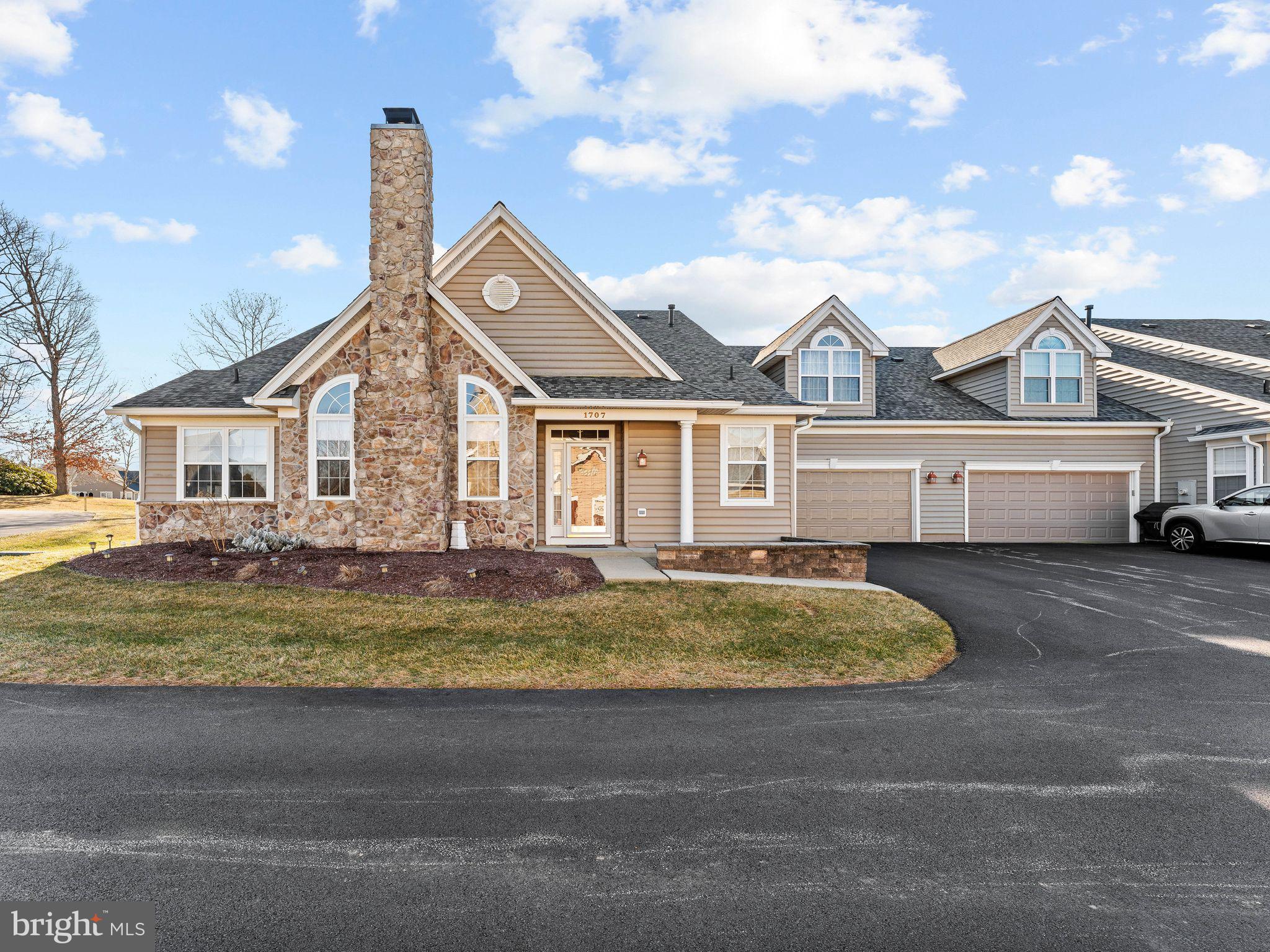 a view of a house with a swimming pool and sitting area