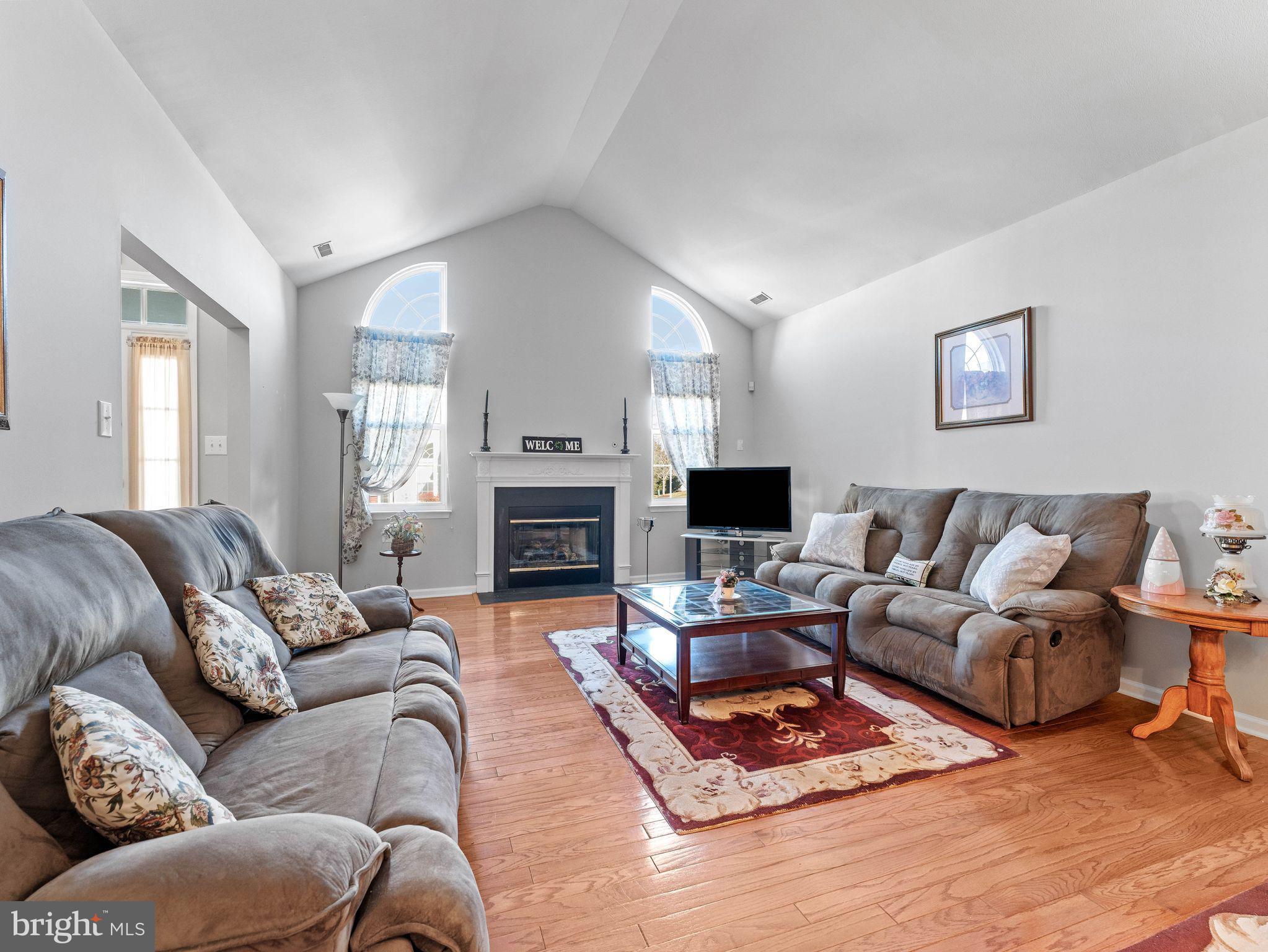 1707 Hulnick Road, Unit 43830 Coatesville, PA 19320 - Photo 11 of 36 a living room with furniture a fireplace and a flat screen tv