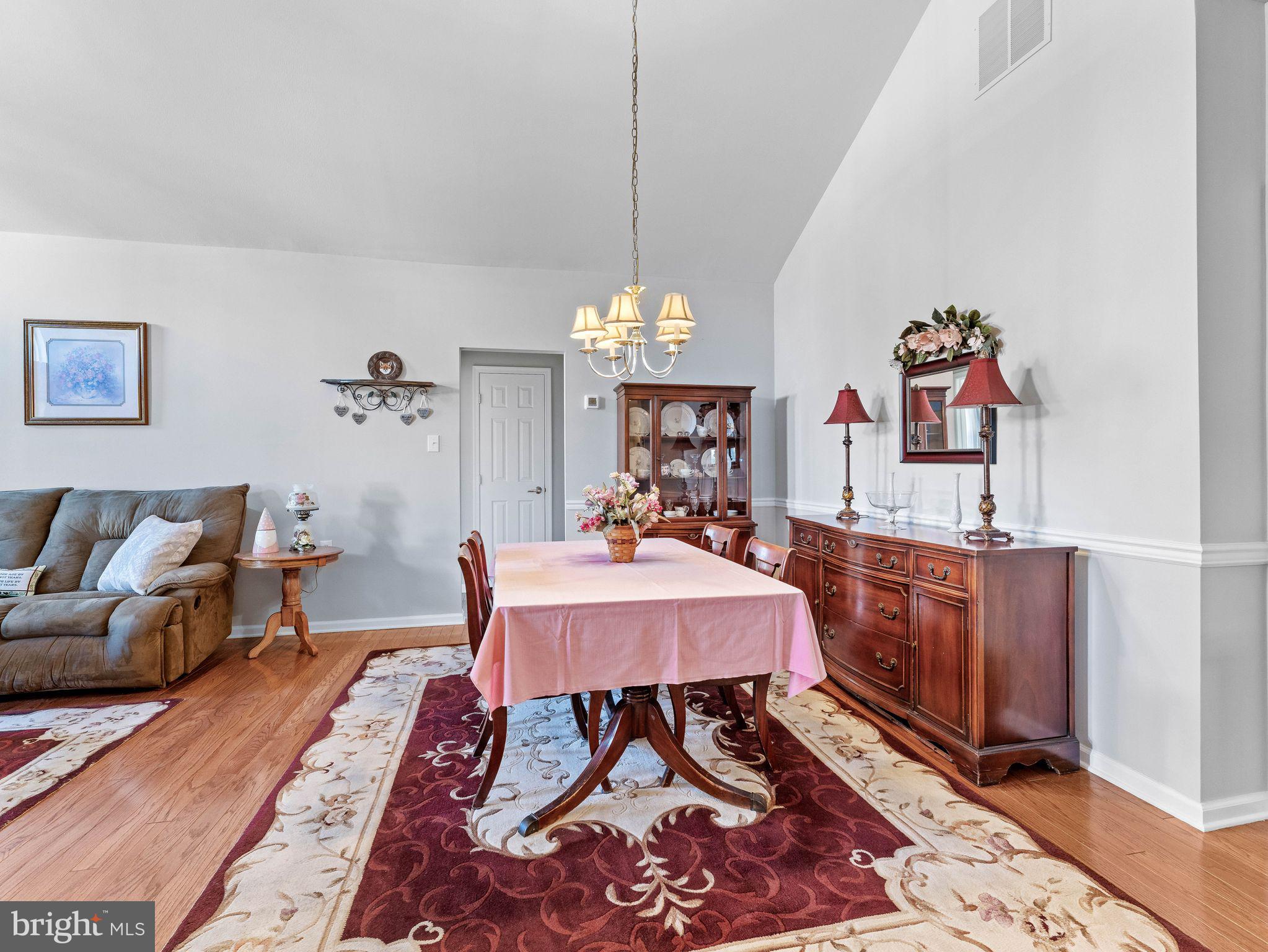 1707 Hulnick Road, Unit 43830 Coatesville, PA 19320 - Photo 13 of 36 a living room with furniture and a chandelier