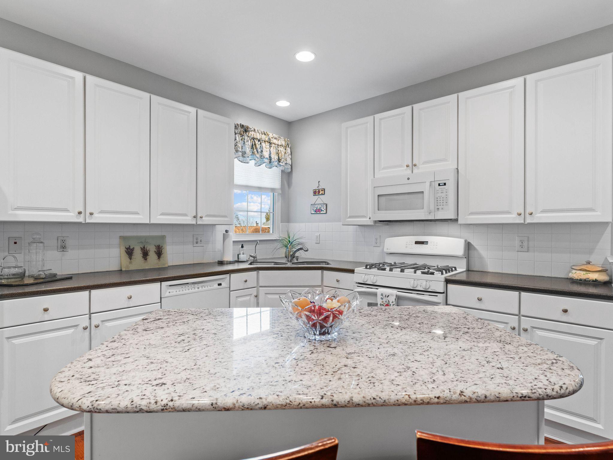 1707 Hulnick Road, Unit 43830 Coatesville, PA 19320 - Photo 18 of 36 a kitchen with stainless steel appliances granite countertop a sink stove and cabinets