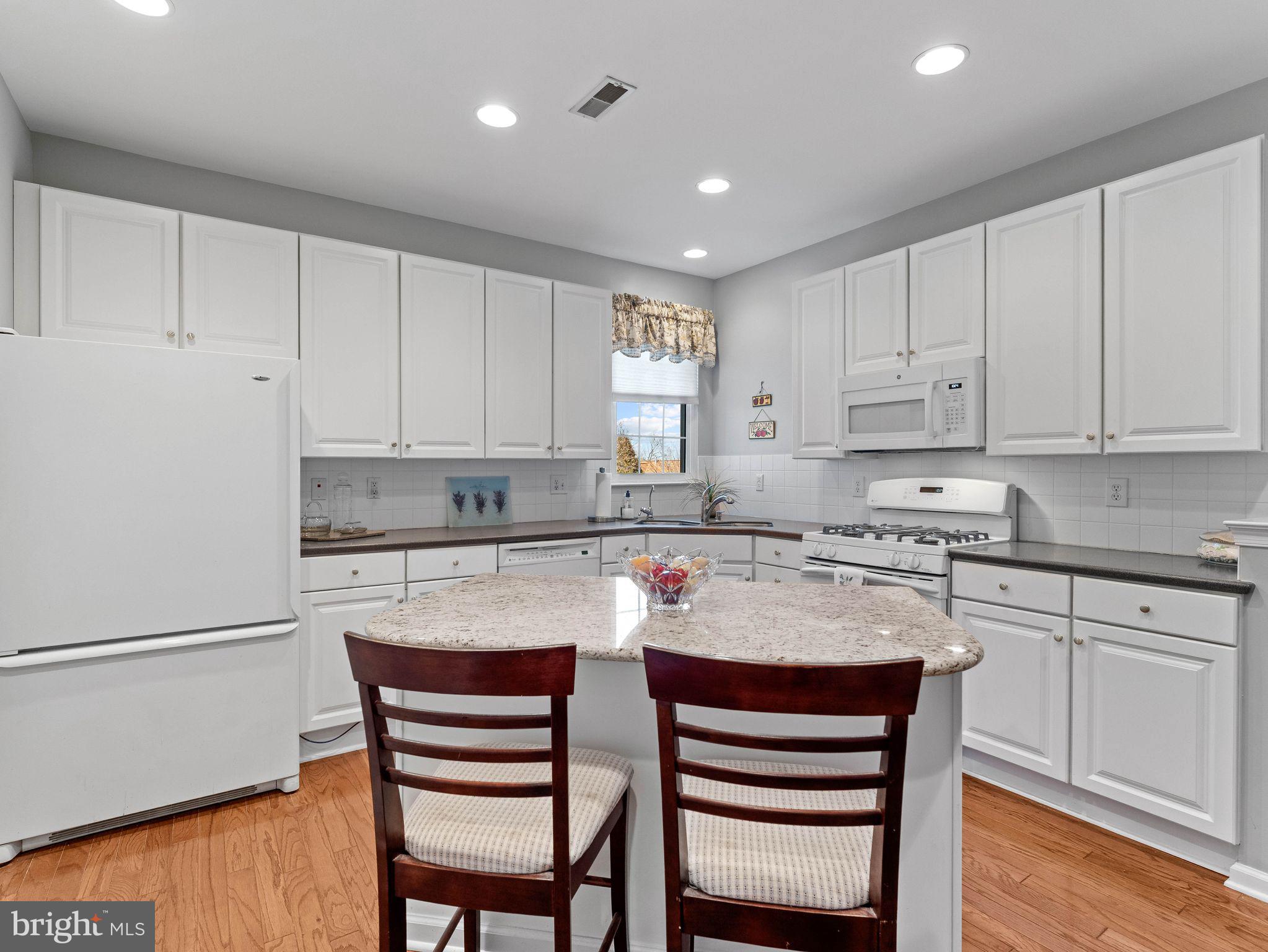 1707 Hulnick Road, Unit 43830 Coatesville, PA 19320 - Photo 23 of 36 a kitchen with stainless steel appliances granite countertop a chairs sink and cabinets