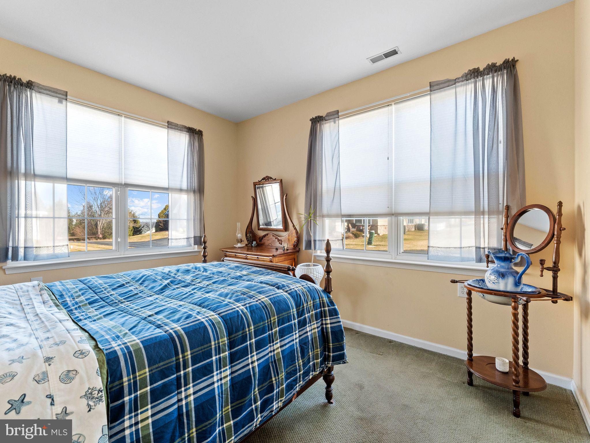 1707 Hulnick Road, Unit 43830 Coatesville, PA 19320 - Photo 30 of 36 a bedroom with a bed a desk and large windows