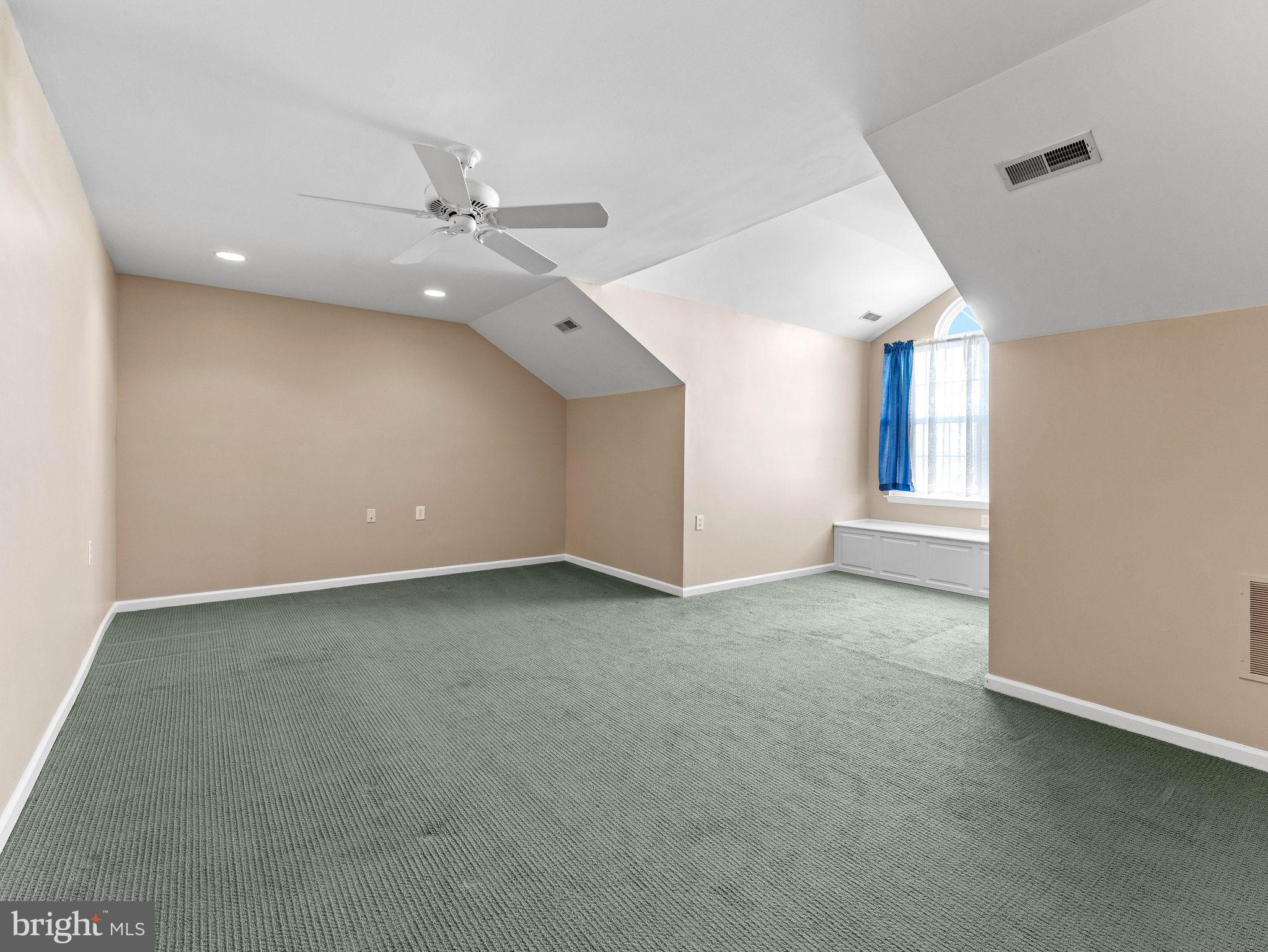 1707 Hulnick Road, Unit 43830 Coatesville, PA 19320 - Photo 34 of 36 an empty room with a ceiling fan and window