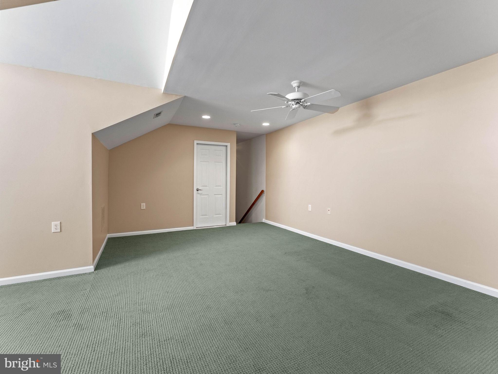 1707 Hulnick Road, Unit 43830 Coatesville, PA 19320 - Photo 35 of 36 an empty room with a ceiling fan and closet area