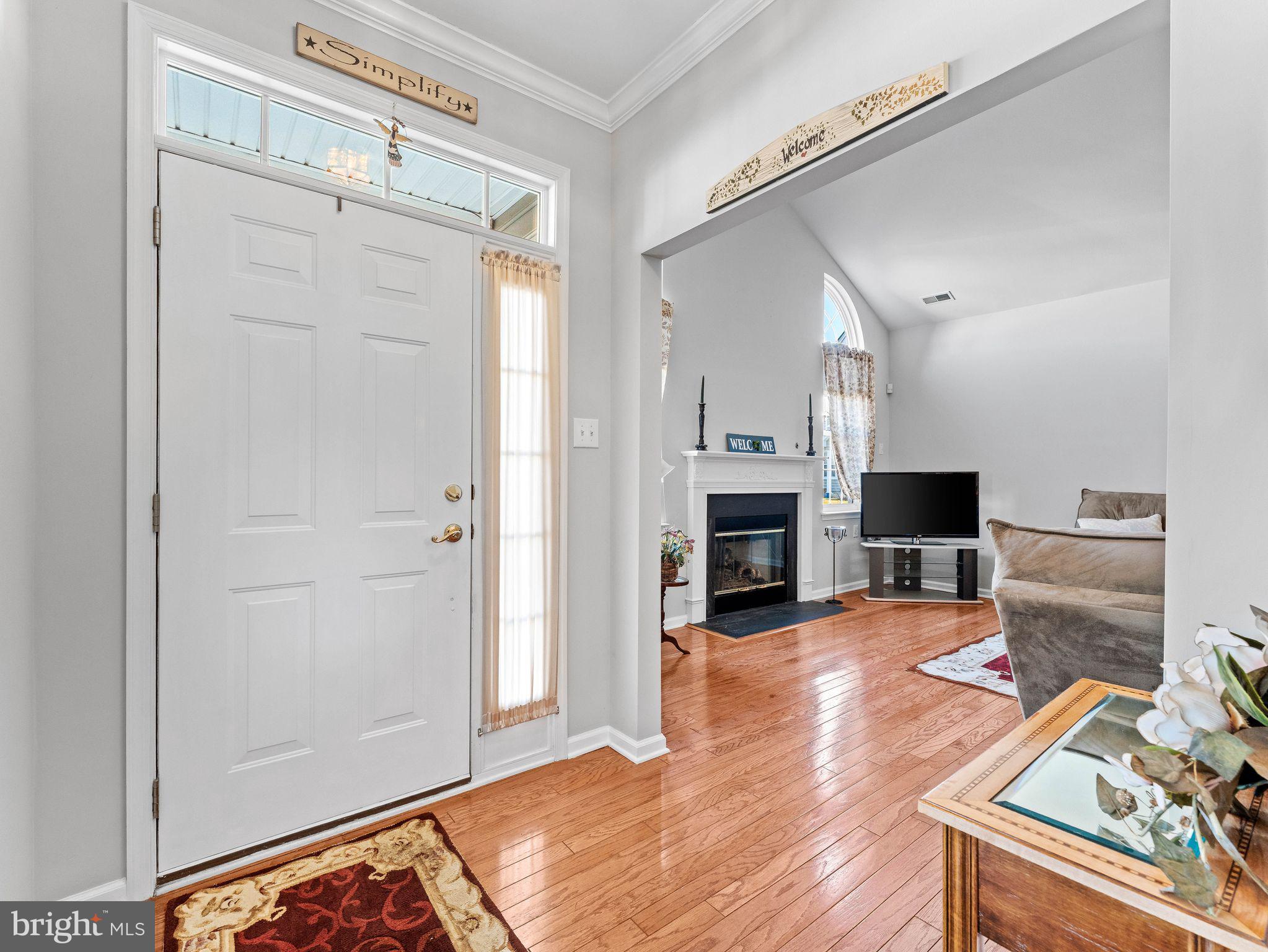 1707 Hulnick Road, Unit 43830 Coatesville, PA 19320 - Photo 5 of 36 a view of a livingroom with a fireplace a chandelier and wooden floor
