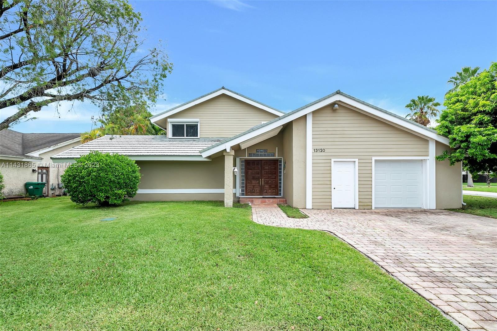a front view of house with yard and green space