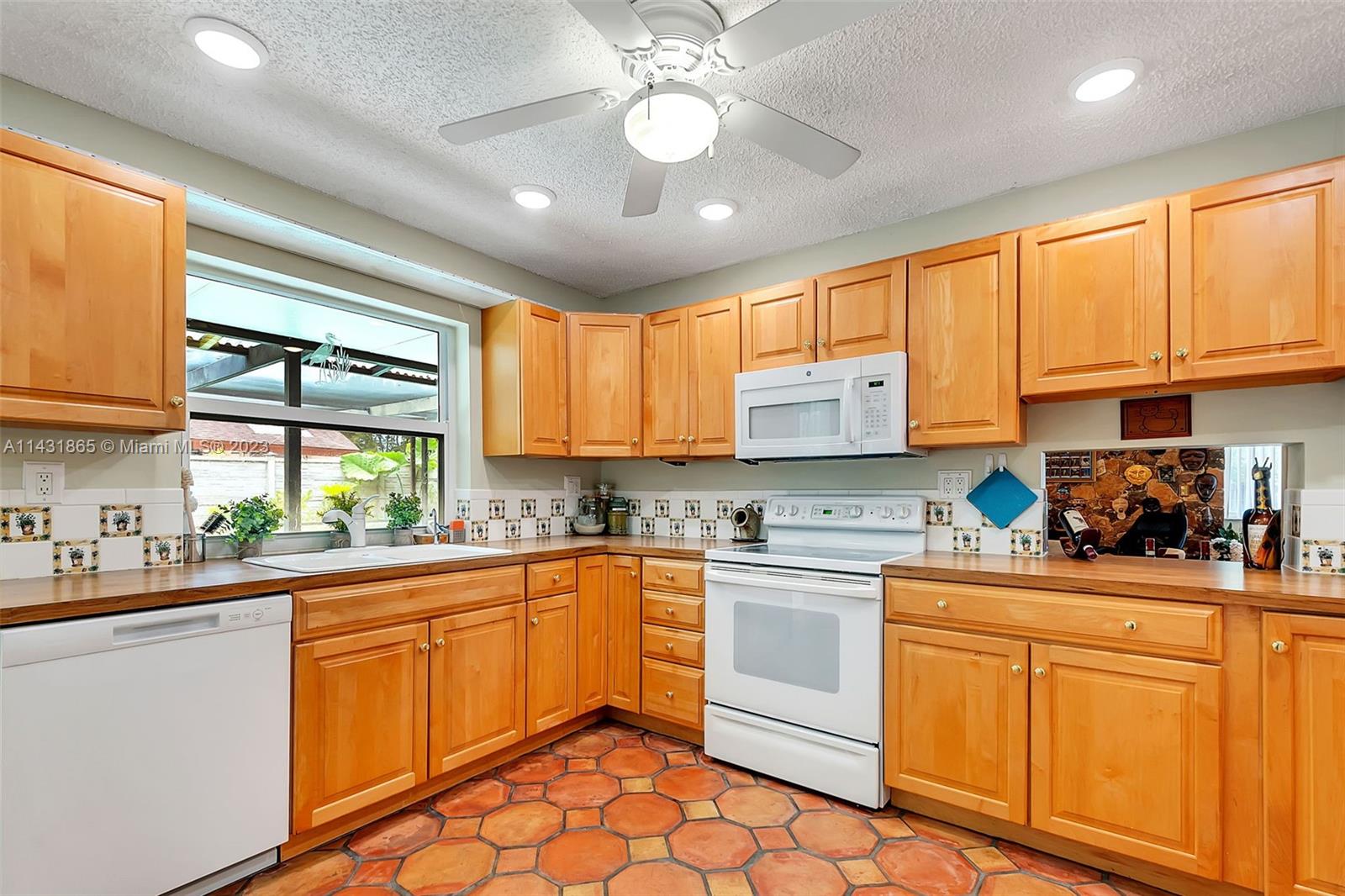 13120 Southwest 117th Street Miami, FL 33186 - Photo 13 of 29 a kitchen with a sink window and cabinets