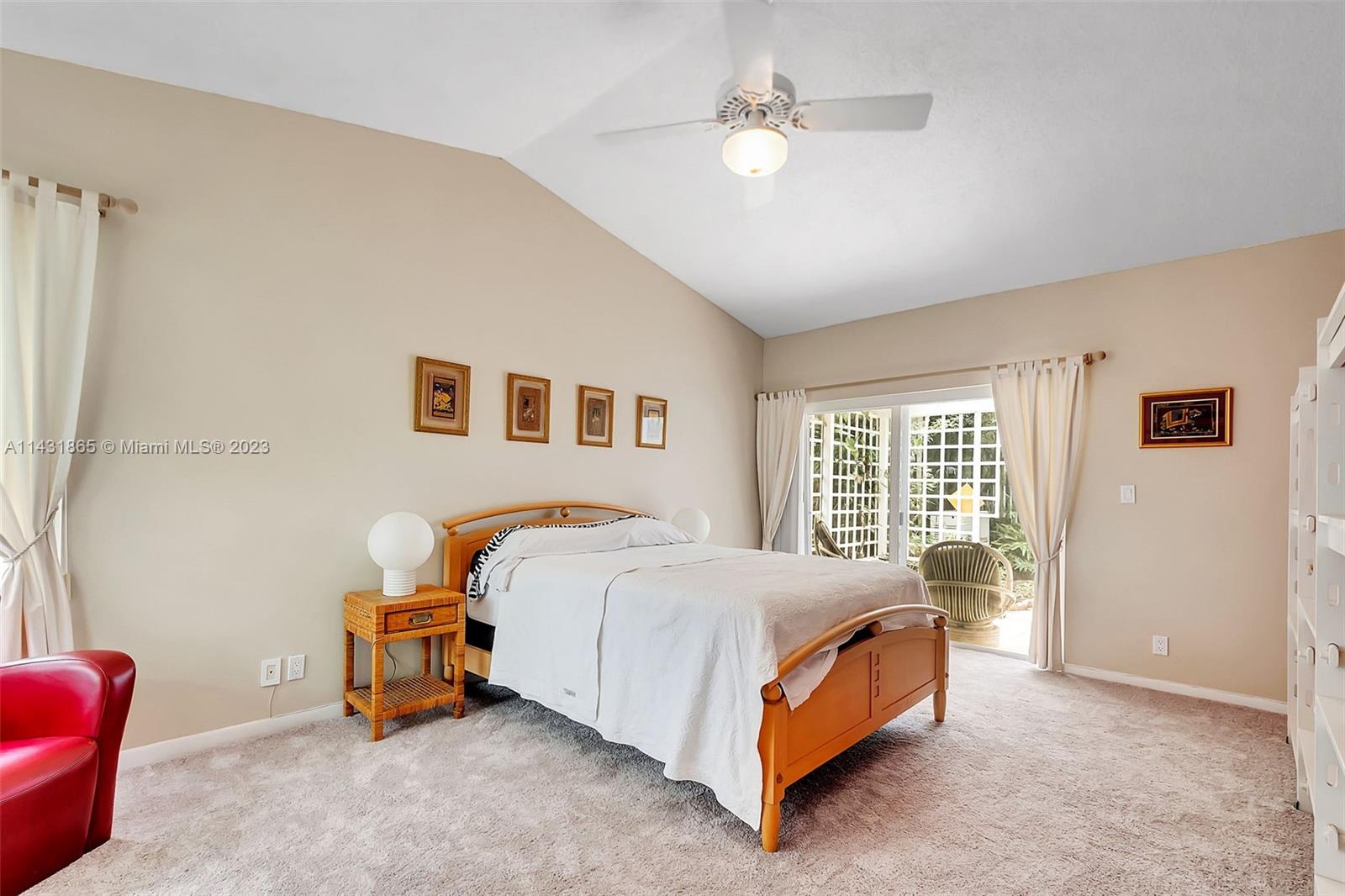 13120 Southwest 117th Street Miami, FL 33186 - Photo 15 of 29 a bedroom with a bed and a chandelier