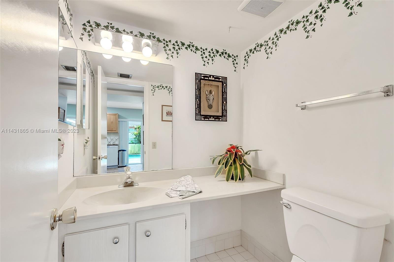 13120 Southwest 117th Street Miami, FL 33186 - Photo 22 of 29 a bathroom with a sink a toilet and mirror
