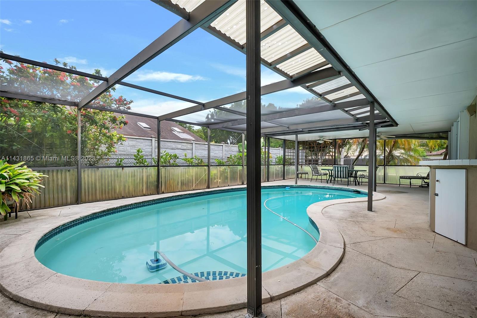13120 Southwest 117th Street Miami, FL 33186 - Photo 25 of 29 a swimming pool with large glass windows and table