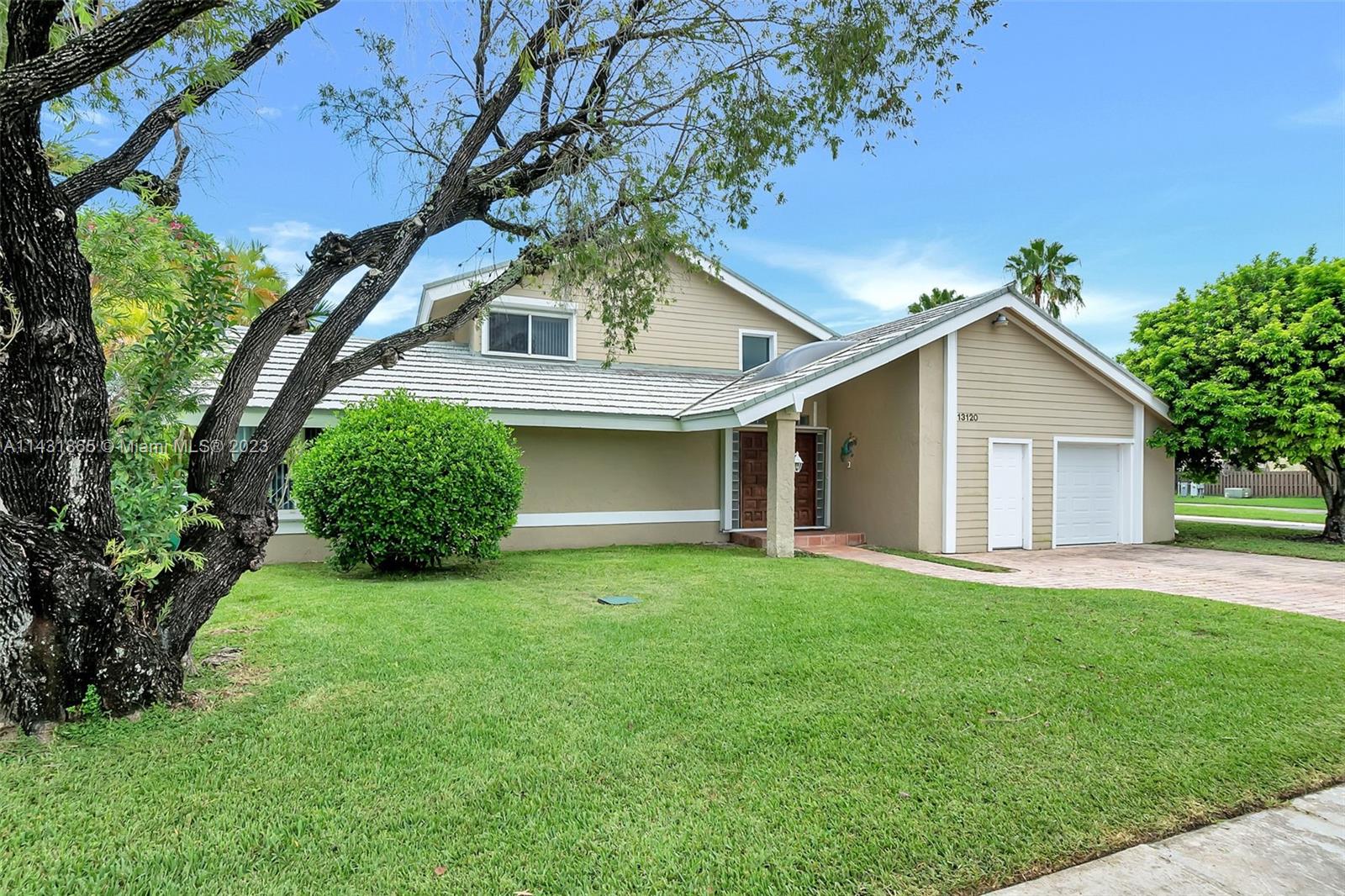 13120 Southwest 117th Street Miami, FL 33186 - Photo 9 of 29 a front view of house with yard and green space