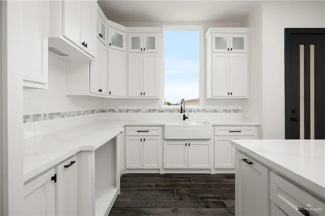 a kitchen with stainless steel appliances granite countertop a sink and dishwasher with white cabinets