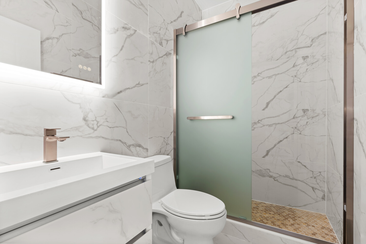 983 Manhattan Avenue, Unit 1 Brooklyn, NY 11222 - Photo 5 of 10 a bathroom with a sink a toilet and shower