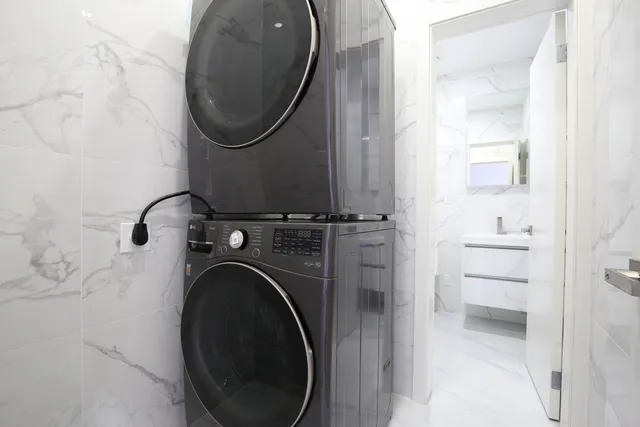 a bedroom with a bed lamp and a window