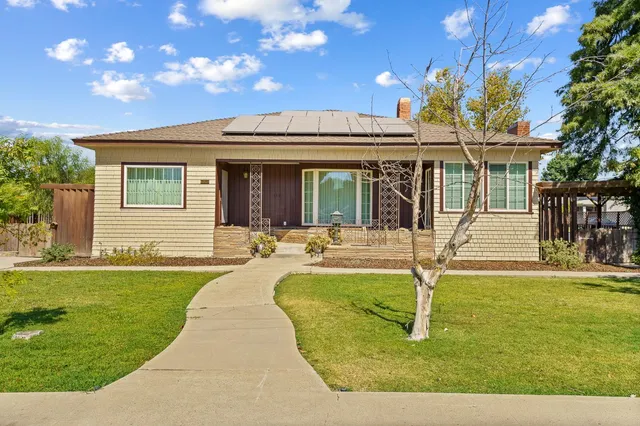 a view of a house with swimming pool and a yard