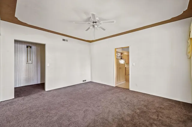 a bathroom with a granite countertop sink a large mirror and a bathtub