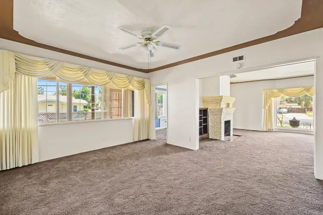 a kitchen with stainless steel appliances a stove a refrigerator a sink a dining table and chairs with wooden floor