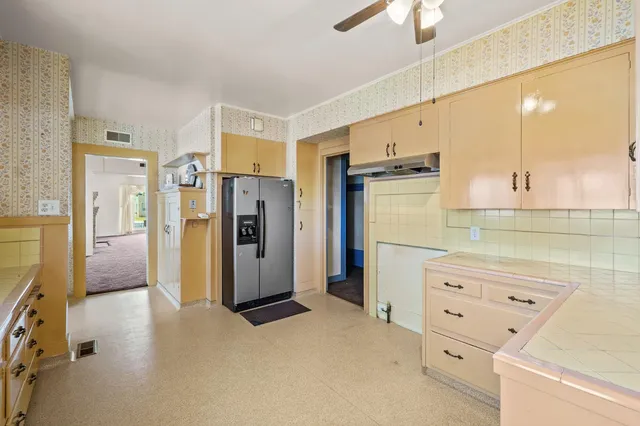 a view of an empty room with a ceiling fan