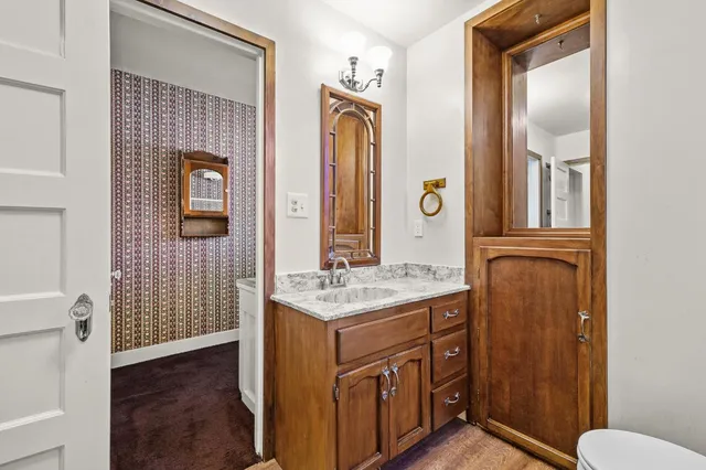 a view of a livingroom with a ceiling fan and entryway
