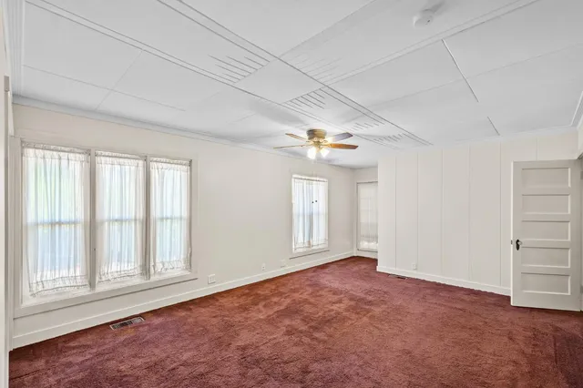 an empty room with windows and closet