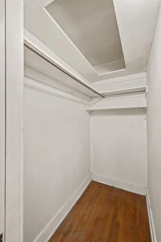 a white toilet sitting next to a bathroom sink and vanity