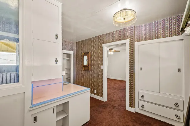 a kitchen with stainless steel appliances a refrigerator sink and white cabinets