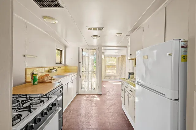 an aerial view of a house with a yard and garden