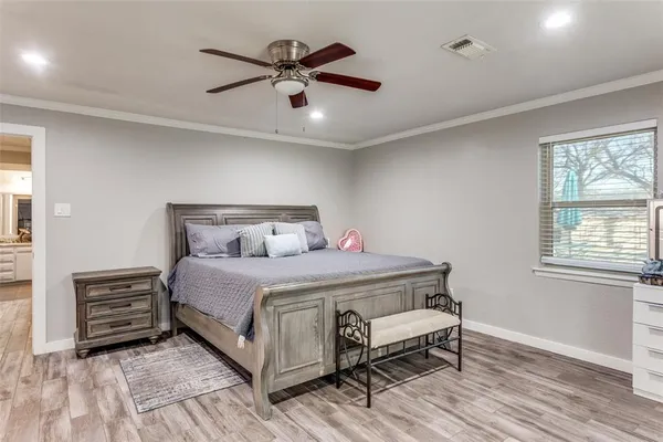 a bathroom with a granite countertop sink mirror and cabinets