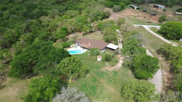 an aerial view of a house with yard swimming pool and outdoor seating