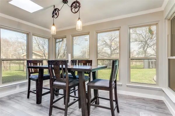 a kitchen with kitchen island granite countertop a sink cabinets and stainless steel appliances