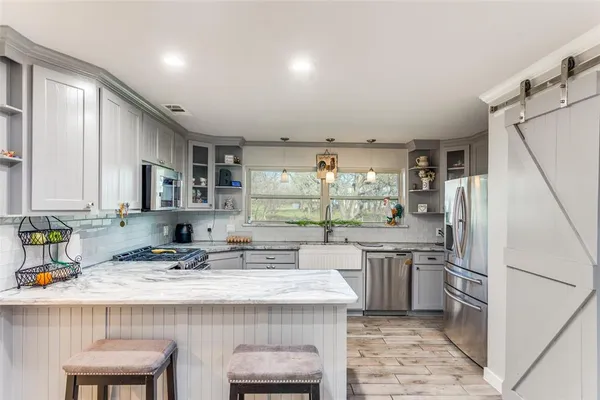 a kitchen with granite countertop a stove and a sink