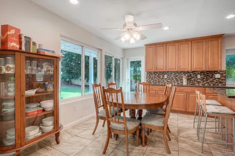 a view of a dining room with furniture and a chandelier