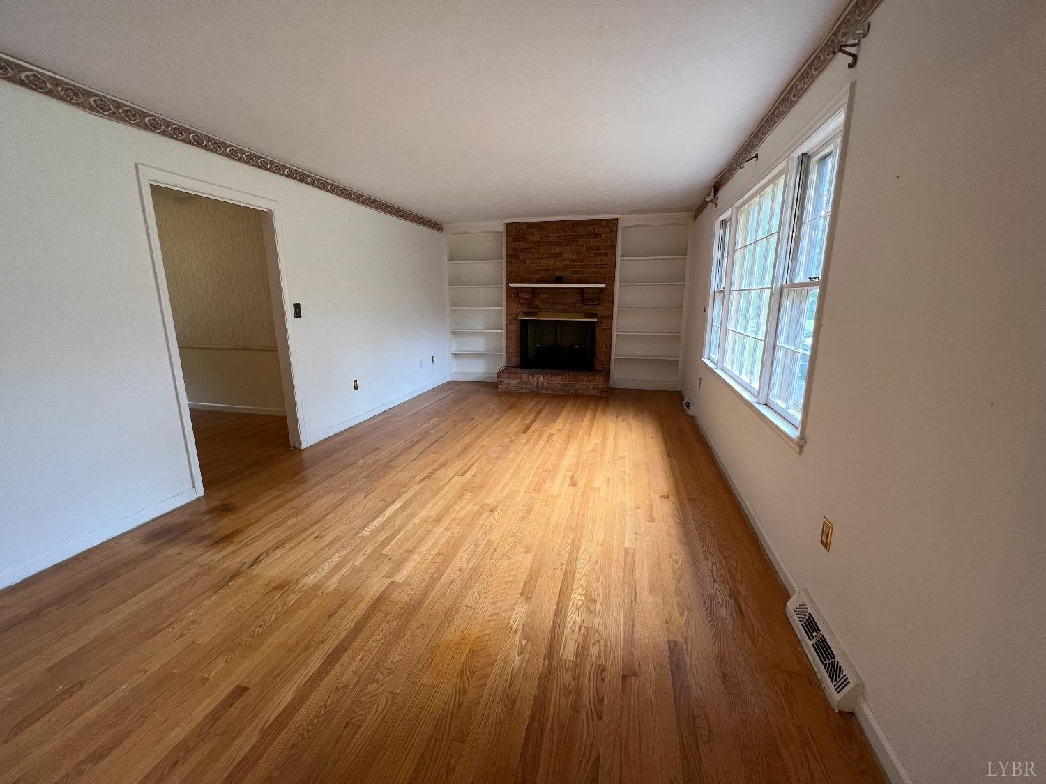 214 Blue Ridge Lane Amherst, VA 24521 - Photo 7 of 36 a view of an empty room with wooden floor and a window
