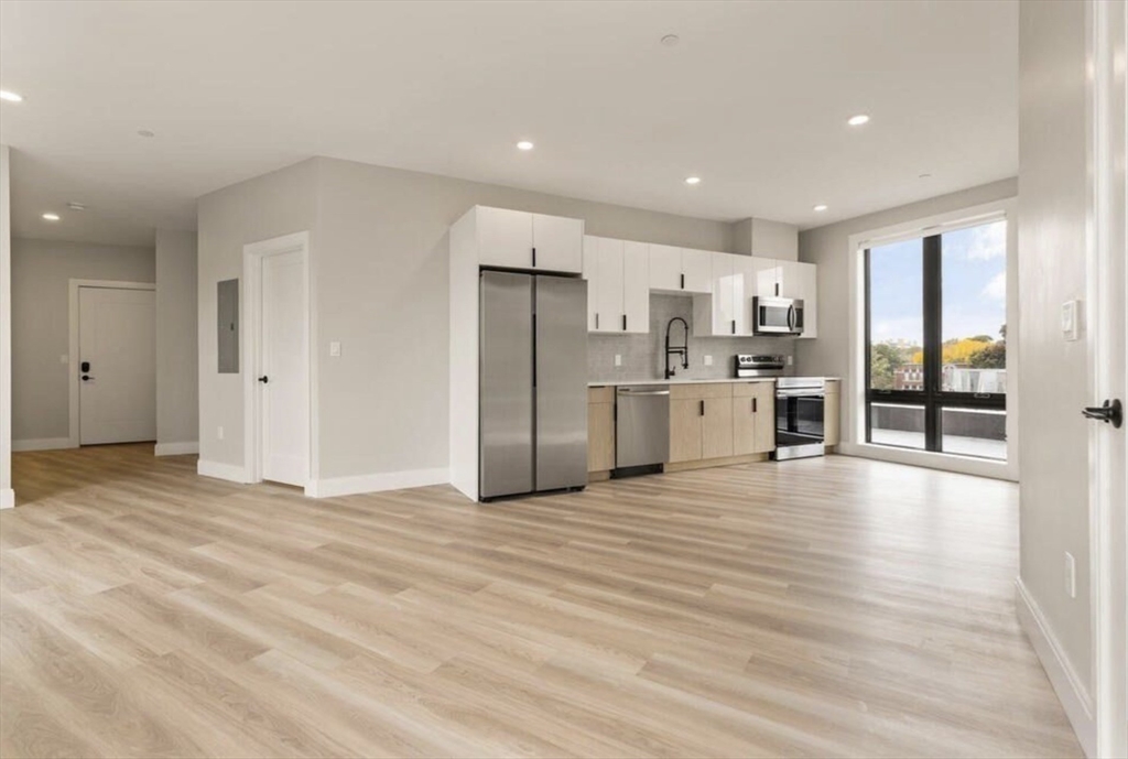 a view of a kitchen with a stove cabinets and wooden floor