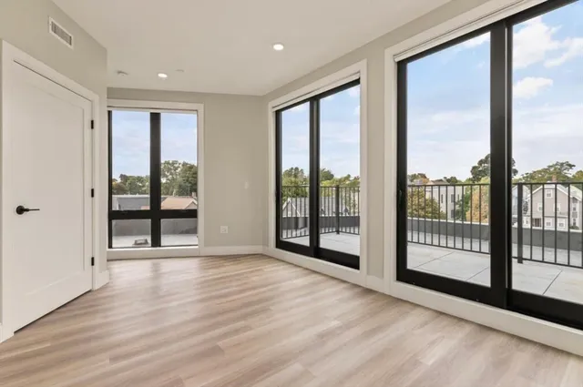 a view of an empty room and glass door