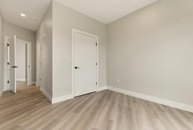 a view of a room with wooden floor
