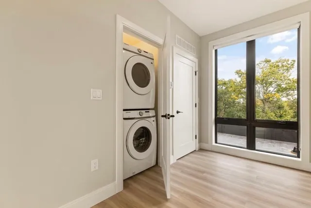 a view of a hallway with washer and dryer