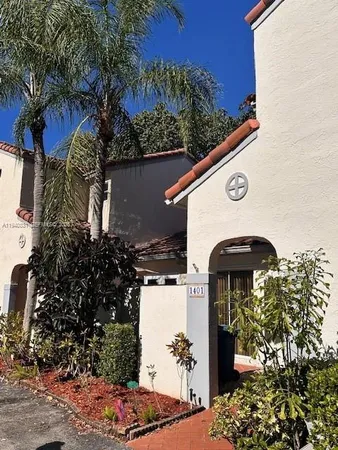 a view of a house with a tree