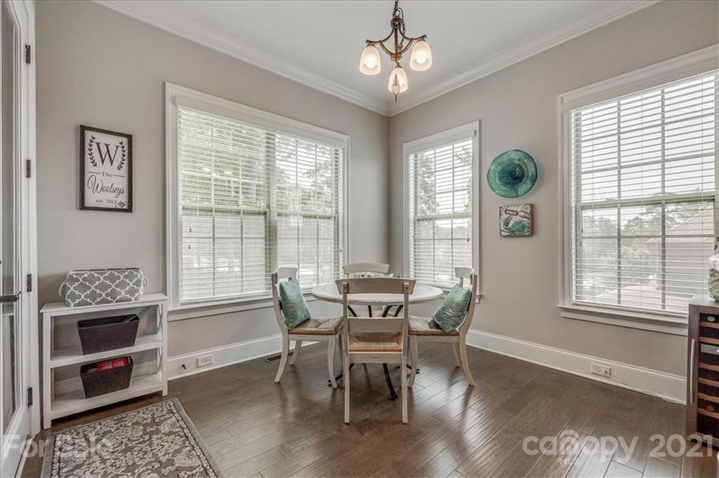 620 Zinnia Way Tega Cay, SC 29708 - Photo 14 of 39 a view of a dining room with furniture window and wooden floor