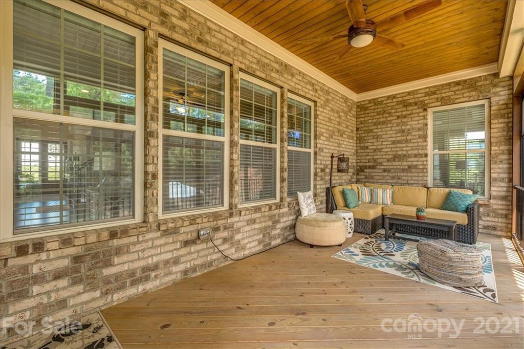 620 Zinnia Way Tega Cay, SC 29708 - Photo 18 of 39 a living room with furniture and floor to ceiling windows
