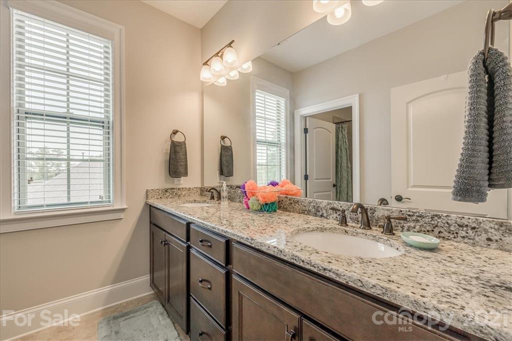 620 Zinnia Way Tega Cay, SC 29708 - Photo 30 of 39 a bathroom with a granite countertop sink and a mirror