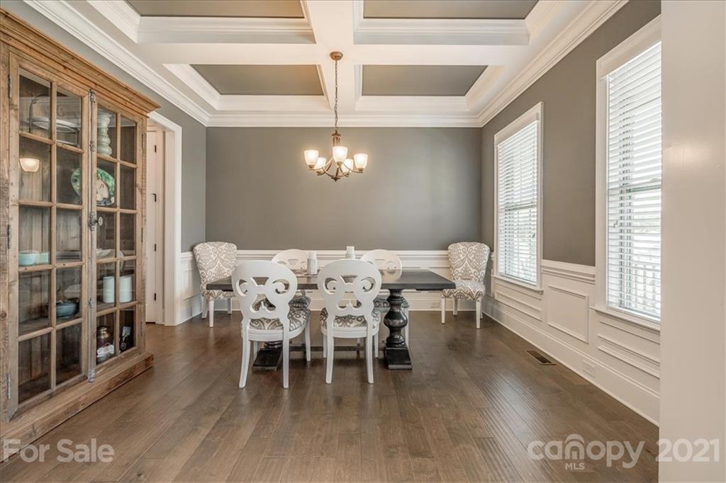 620 Zinnia Way Tega Cay, SC 29708 - Photo 9 of 39 a dining room with furniture a chandelier and wooden floor