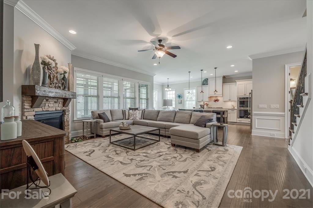 620 Zinnia Way Tega Cay, SC 29708 - Photo 10 of 39 a living room with furniture kitchen view and a fireplace